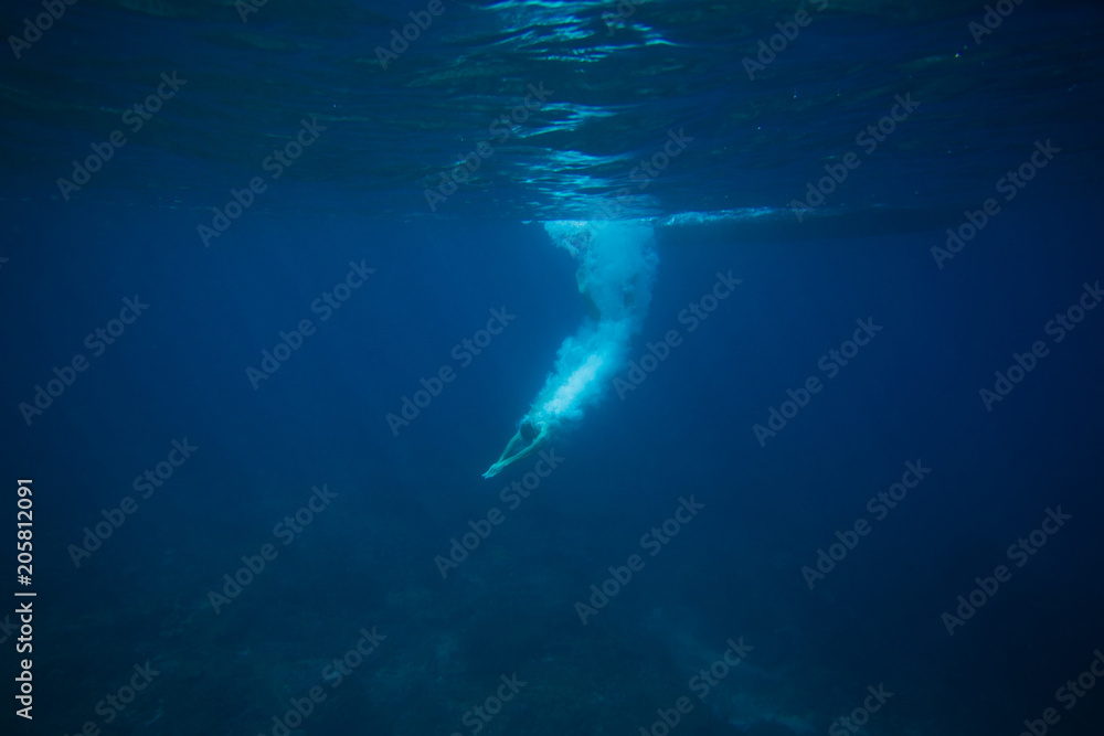 partial view of man diving into ocean
