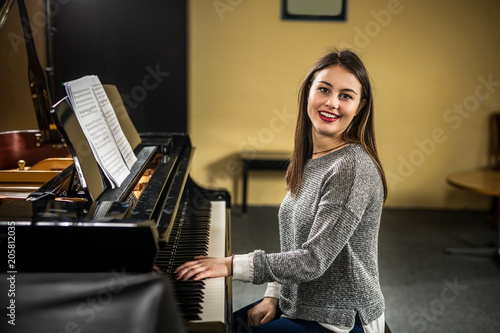 Murais de parede A pianist pays a piano in the camera and laughs