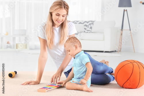 Baby and mother playing wit...