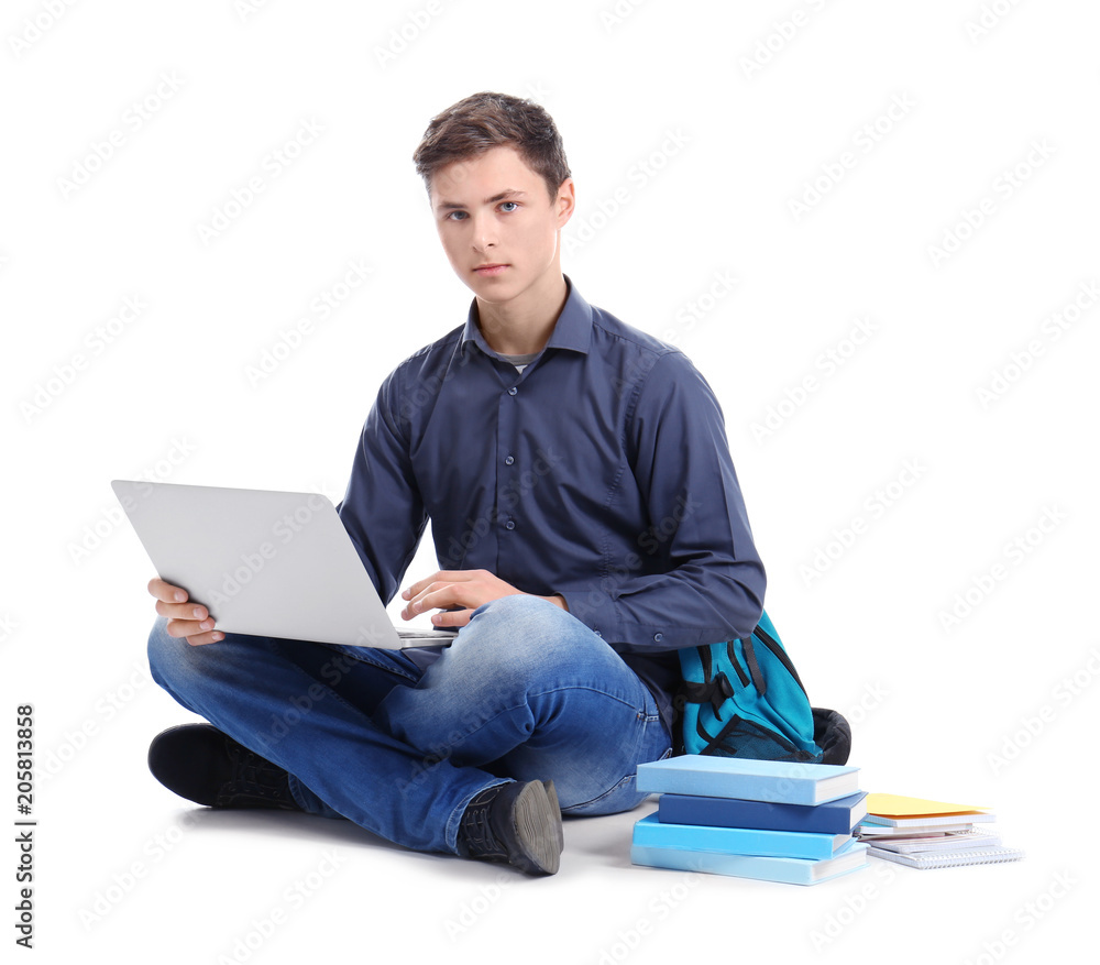 Stylish teenager using laptop against white background Stylish teenager using laptop against white background