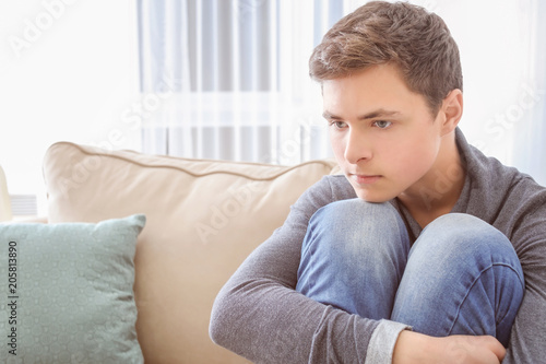 Depressed teenager sitting ...