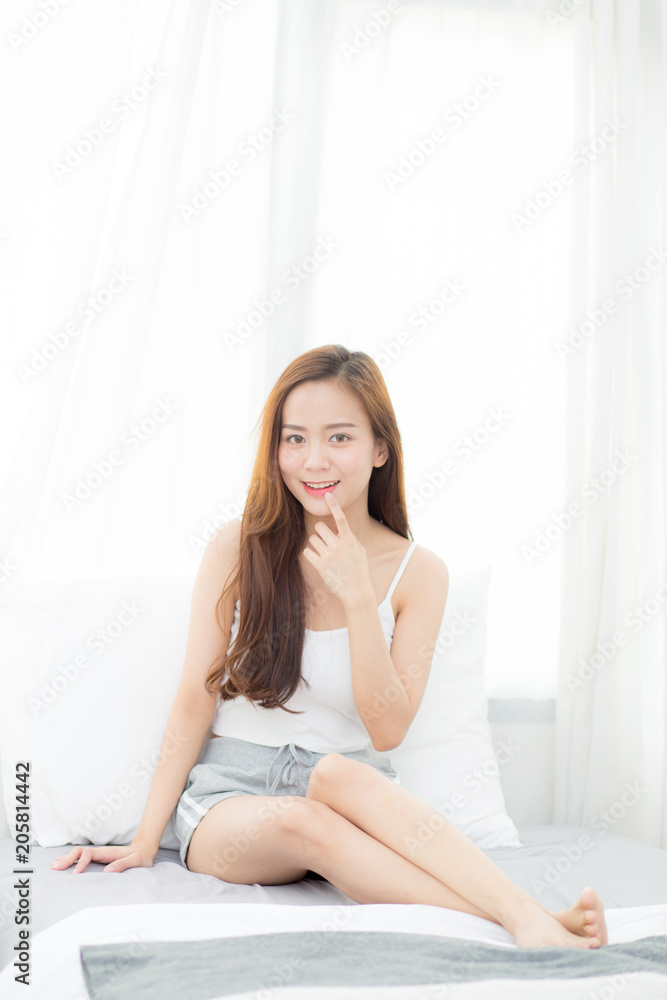 Portrait beautiful young asian woman sitting and smile the window at bedroom while wake up with sunrise at morning, lifestyle and relax concept. Portrait beautiful young asian woman sitting and smile the window at bedroom while wake up with sunrise at morning, lifestyle and relax concept.