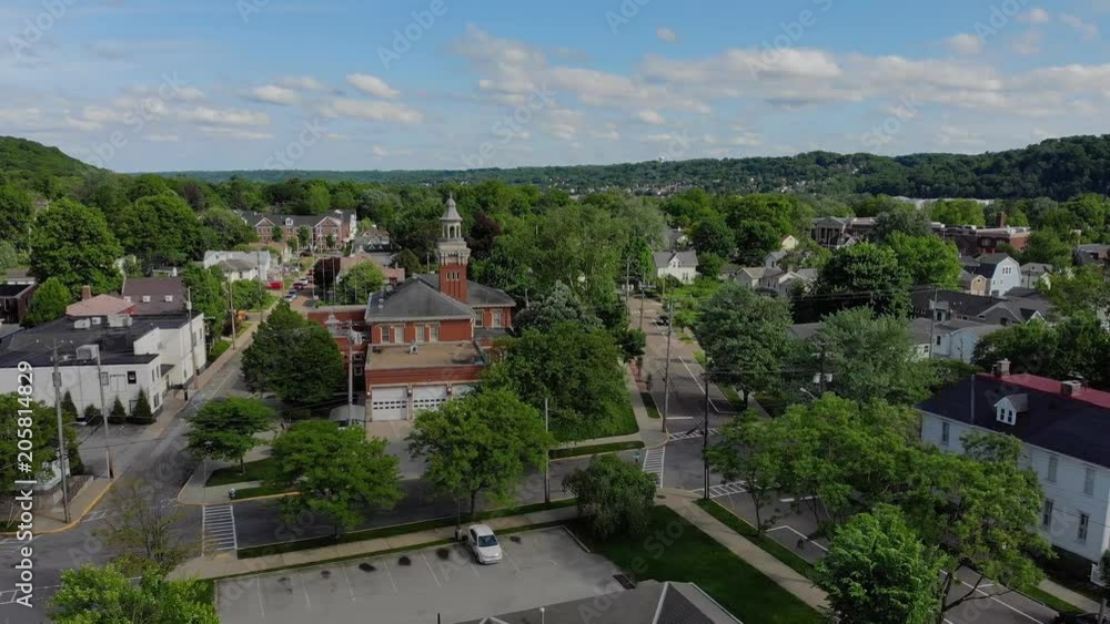 A slow moving forward wide aerial establishing shot of the steeple of a city hall in the small New England town. Pittsburgh suburbs. A slow moving forward wide aerial establishing shot of the steeple of a city hall in the small New England town. Pittsburgh suburbs.