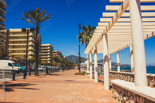 Promenade. A sunny day on the beach of Fuengirola. Malaga province, Andalusia, Spain. Picture taken – 15 may 2018. photo