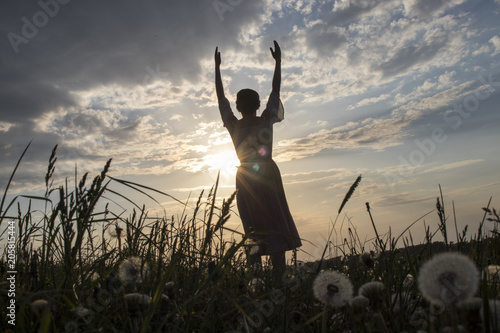 Dance and yoga performance ritual by sunset