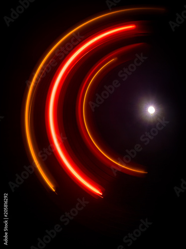 Music concept. Freezelight glowing vinyl on dark background or Turntable playing vinyl with glowing abstract lines concept on dark background.