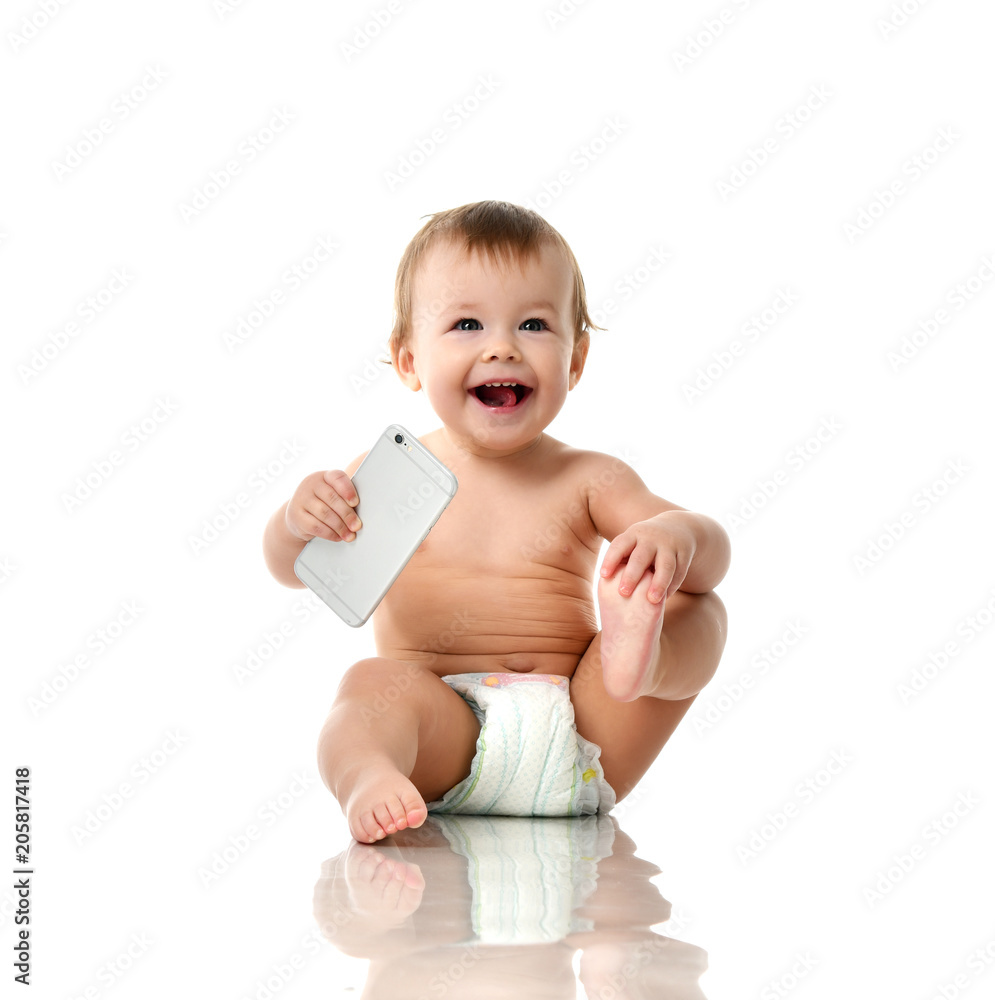 Infant child baby girl toddler playing with mobile cellphone happy smiling Infant child baby girl toddler playing with mobile cellphone happy smiling