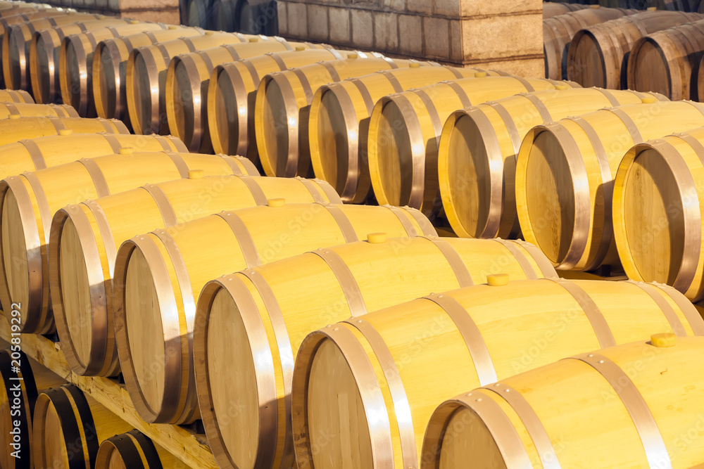 Wine barrels stacked in the cellar of the winery Wine barrels stacked in the cellar of the winery