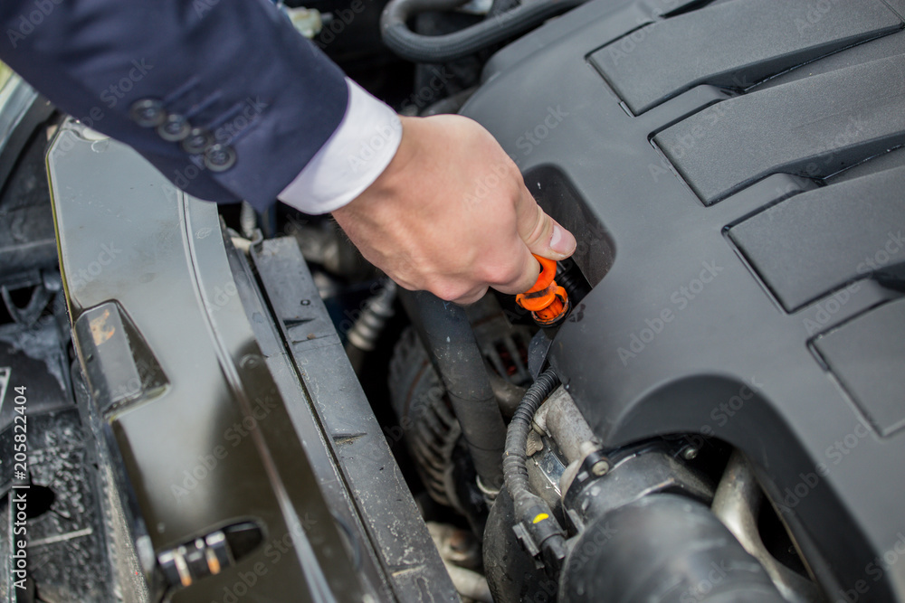 Checking the level of oil in the car's engine, to protect against possible car damage Checking the level of oil in the car's engine, to protect against possible car damage