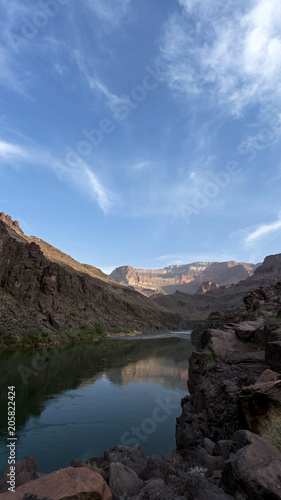 Campsite at dawn. Colorado River runs through Grand Canyon providing exciting whitewater rafting and incredible views along the way. Numerous side canyons can be hiked, often to beautiful waterfalls.