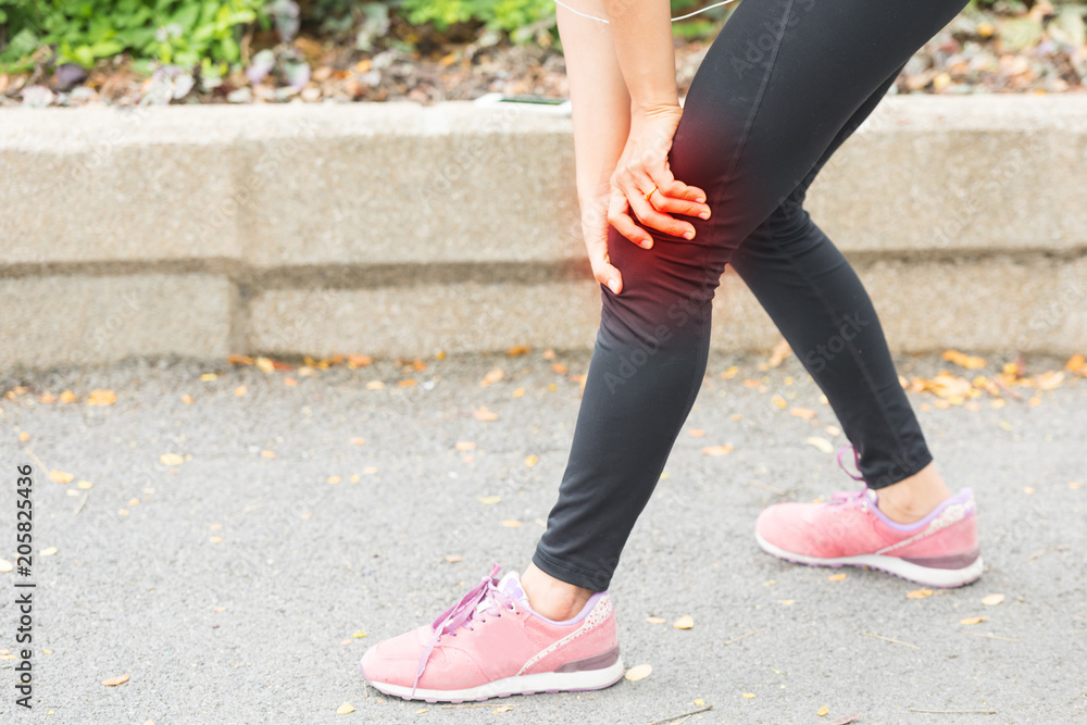 woman runner hold her sports injured knee woman runner hold her sports injured knee