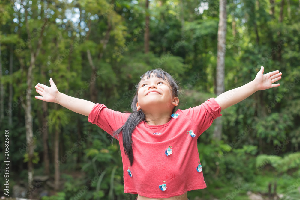 Happy child relaxing outdoors in spring filed Happy child relaxing outdoors in spring filed