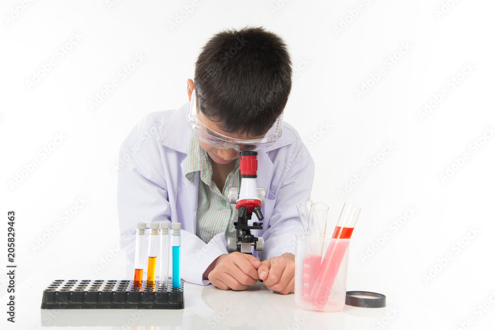 Little boy with flasks and microscpope equipment for chemistry science class Little boy with flasks and microscpope equipment for chemistry science class