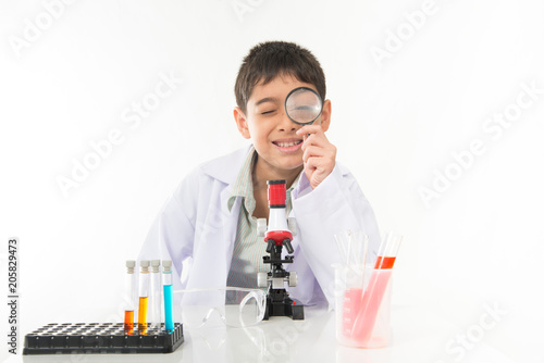 Little boy with flasks  and microscpope equipment for chemistry science class