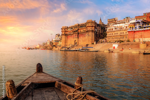 Fotografie, Obraz Varanasi ancient city architecture at sunset as viewed from a boat on river Ganges