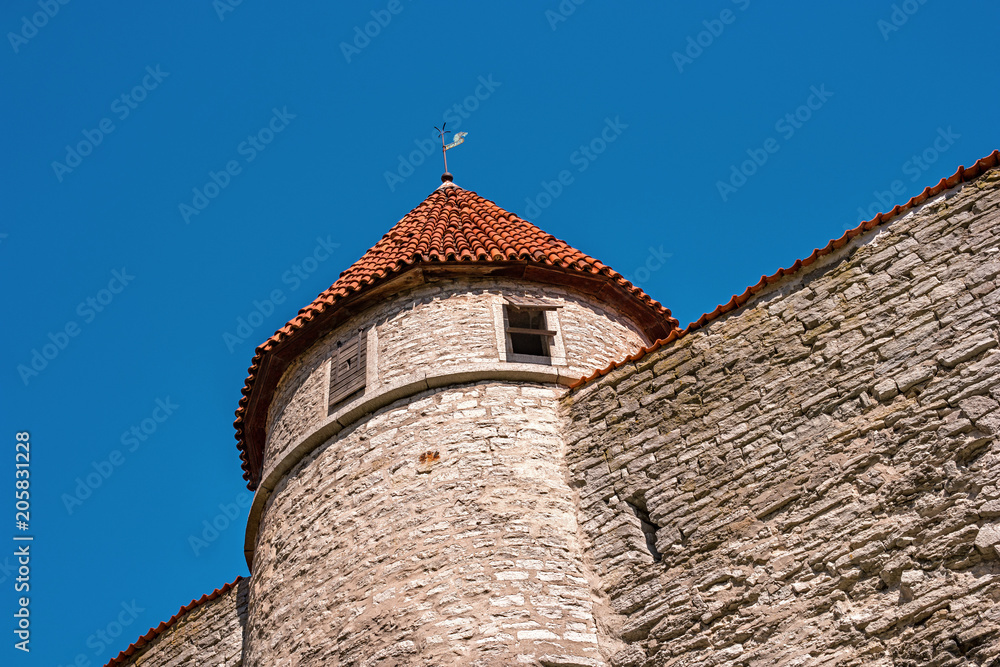 Medieval fortress with towers in the Old town. Tallinn, Estonia. The towers have a red tiled roof