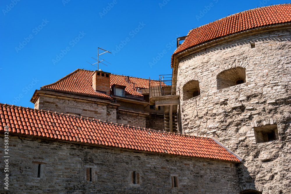 Medieval fortress with towers in the Old town. Tallinn, Estonia. The towers have a red tiled roof