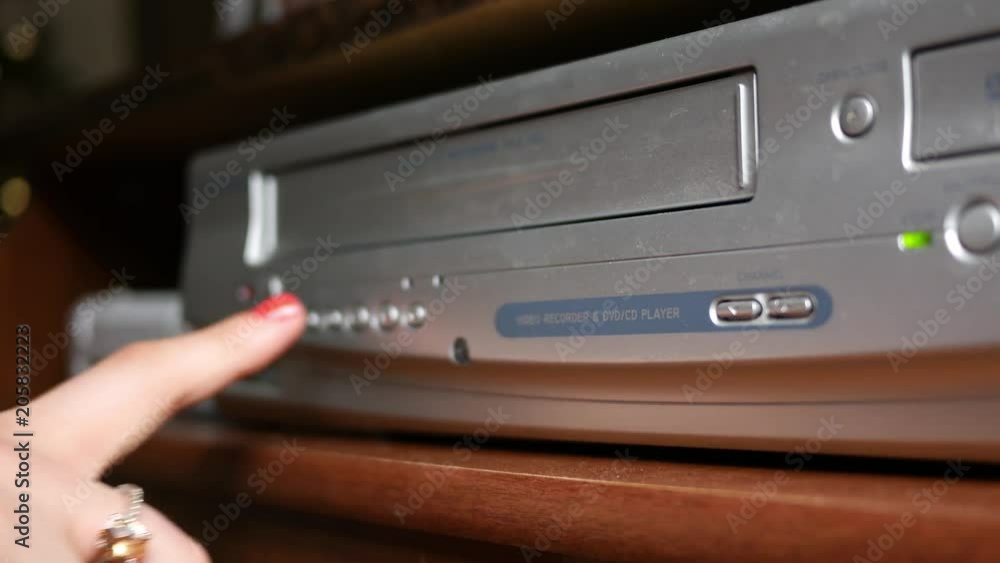 Removing a VHS Tape into VHS player Pushing stop then ejecting 素材庫影片