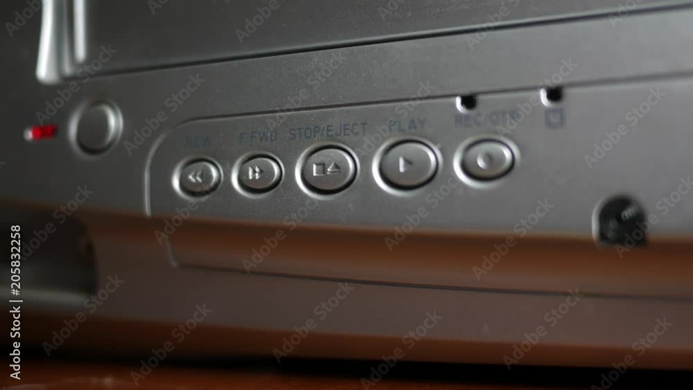 Playing or watching a VHS Tape in a player - pressing button Playing or watching a VHS Tape in a player - pressing button
