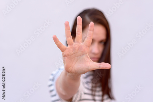 Young woman with hand in front of face