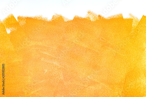 Fototapeta Naklejka Na Ścianę i Meble -  orange acrylic paint roller strokes texture on white wall
