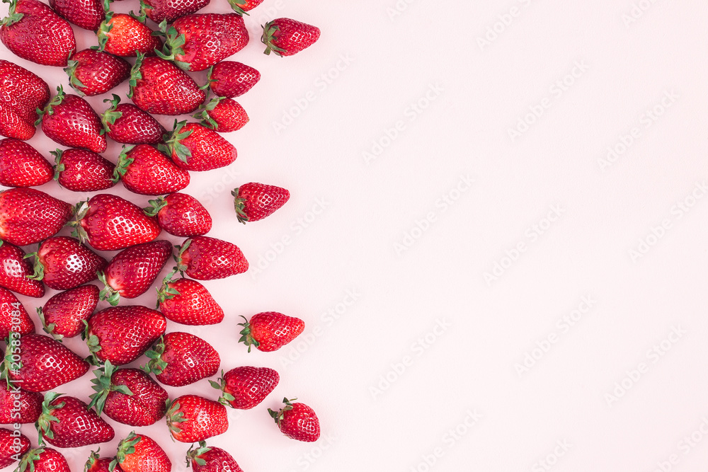 Fototapeta premium Strawberry on pastel pink background. Flat lay, top view, copy space