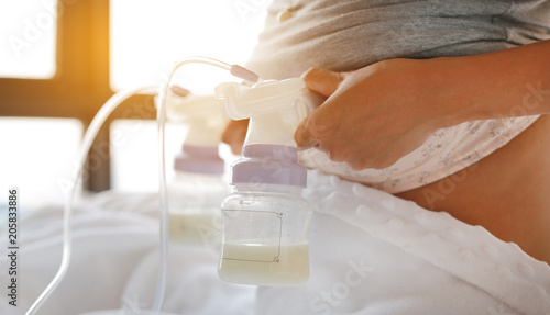 Mother using automatic breast pump.
