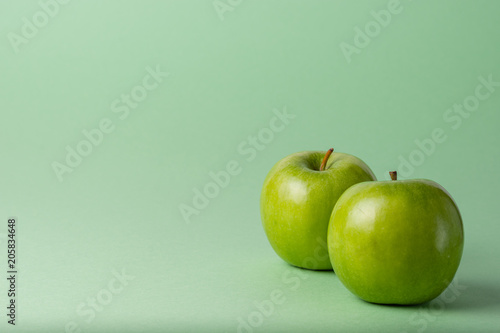 Apples isolated on green background