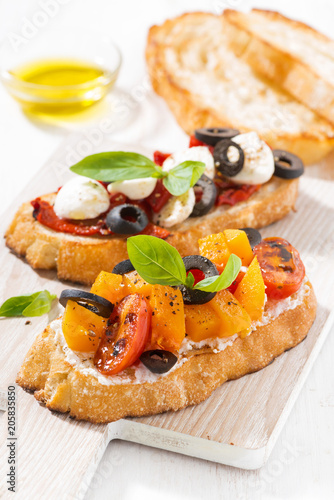 italian appetizer - bruschetta on wooden board, vertical