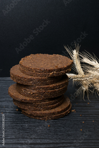 Freshly baked homemade artisan sourdough ry. Rye round sliced gallets. Top view. Close up. Copy space. photo