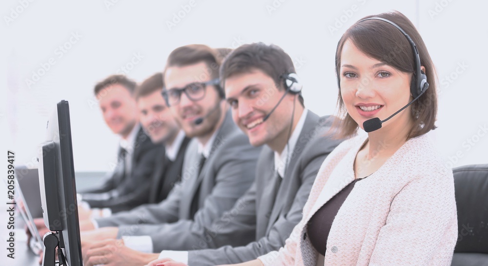 female customer service representative and colleagues in the call center female customer service representative and colleagues in the call center
