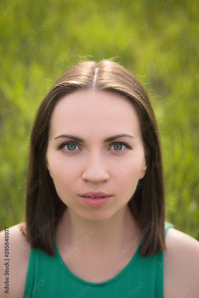 Outdoors portrait of young dark hair woman close-up