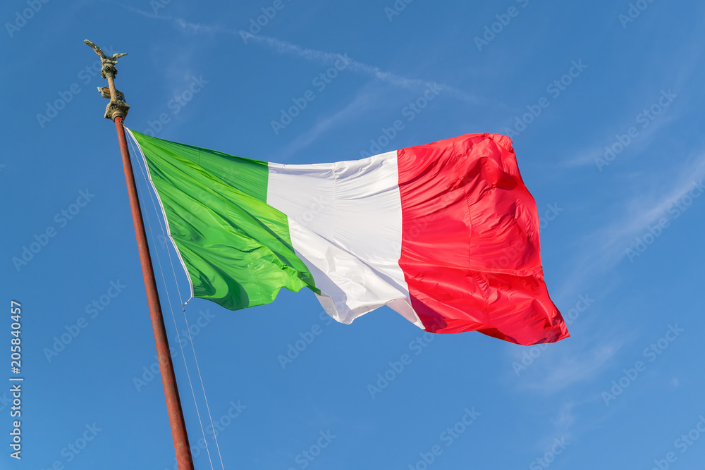 Naklejka premium Flag of Italy against the blue sky