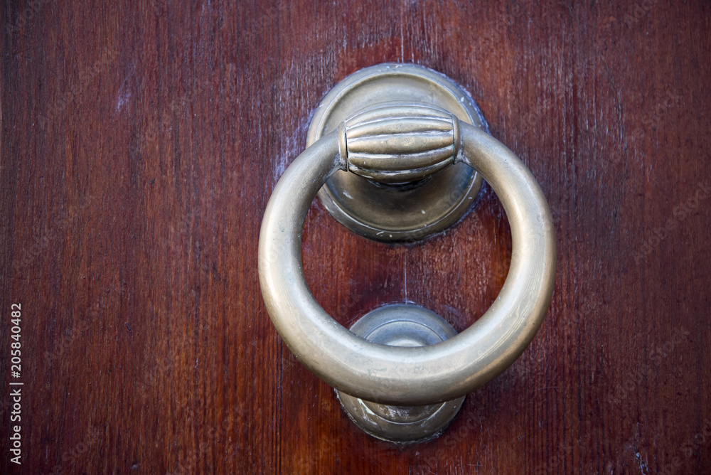 Decorative metal ring knock door, in Italy most homes have doors with these handles.