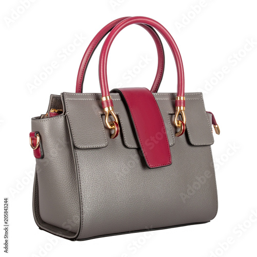 Fashionable gray classic ladies handbag of solid textured leather with a claret flap and inserts and gold accessories three-quarter view, isolated on a white background