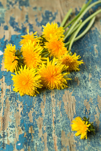 Fototapeta Naklejka Na Ścianę i Meble -  dandelions on rustic wooden surface. floral background