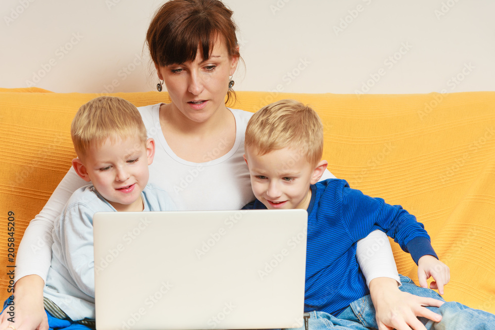Two little boys and mother using laptop Two little boys and mother using laptop