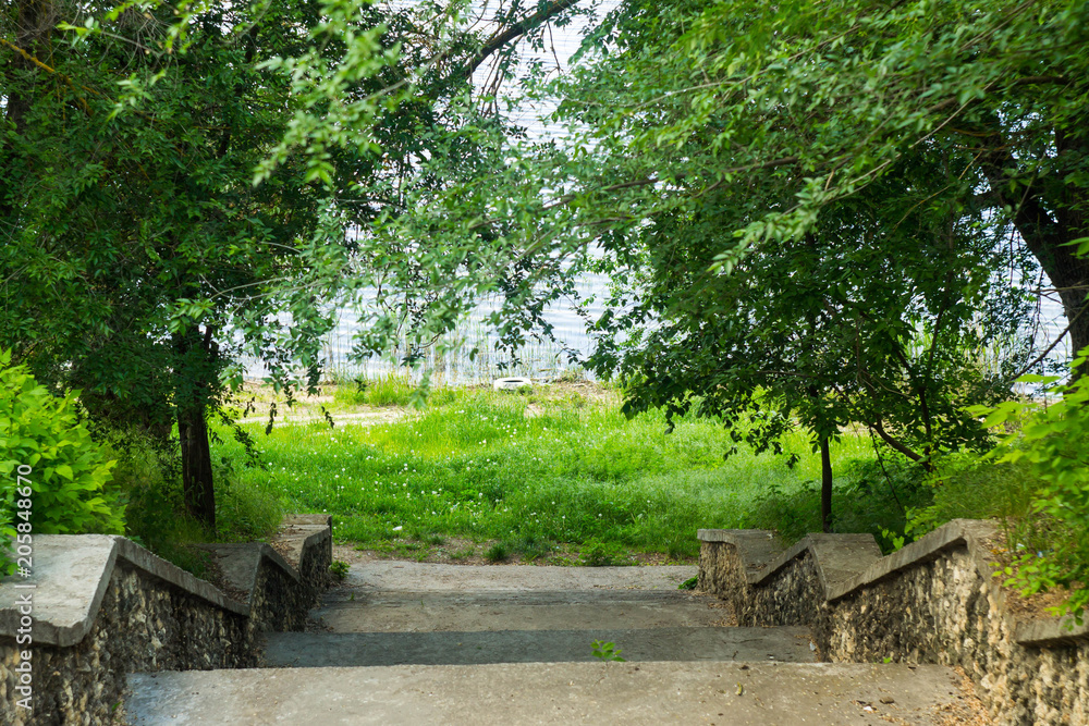 The bank of the river, descent to the water staircase. Spring time The bank of the river, descent to the water staircase. Spring time