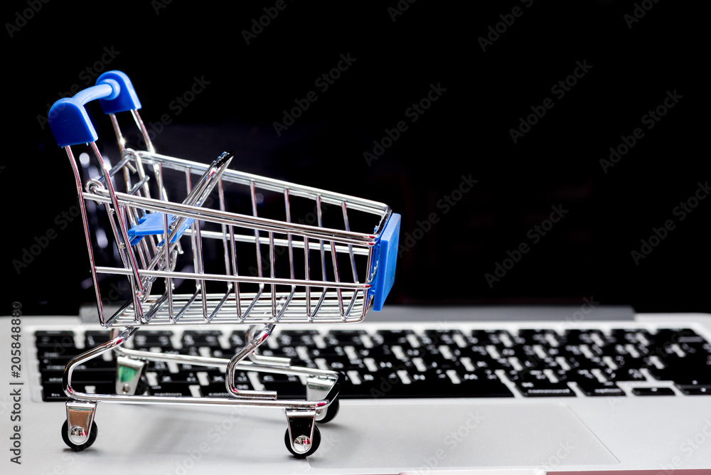 close up of Cart on keyboard computer with tablet background (Online shopping)