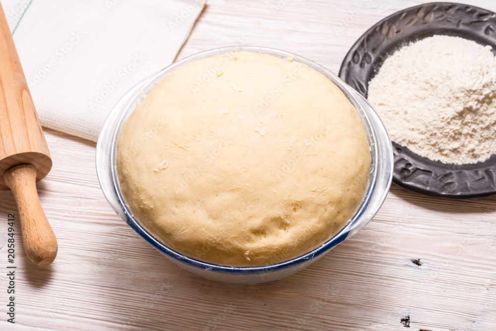 Yeast dough on wooden table. Yeast dough on wooden table.