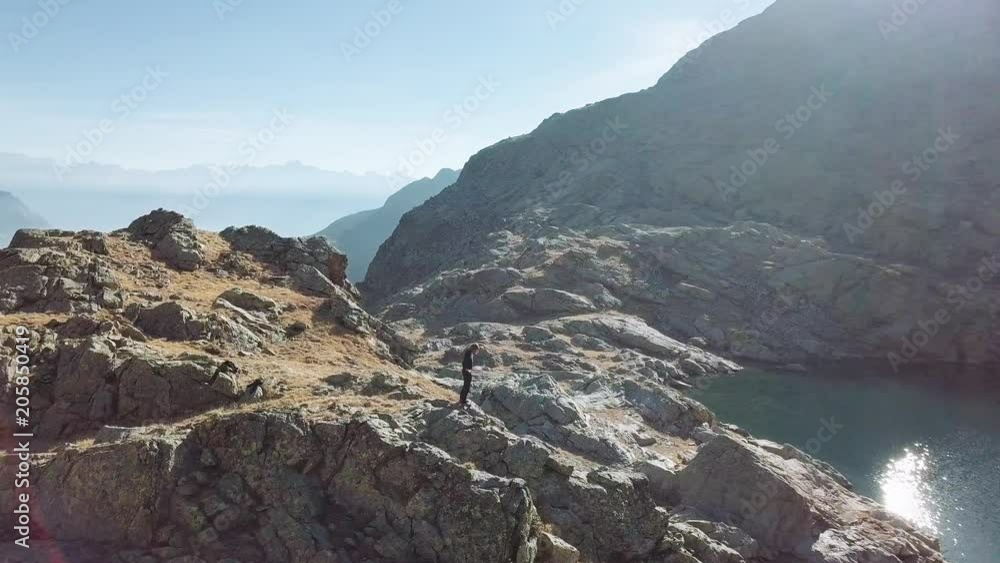 Caucasian man relaxes and meditates with serene view mountains and lake landscape. Aerial view, 4k Caucasian man relaxes and meditates with serene view mountains and lake landscape. Aerial view, 4k