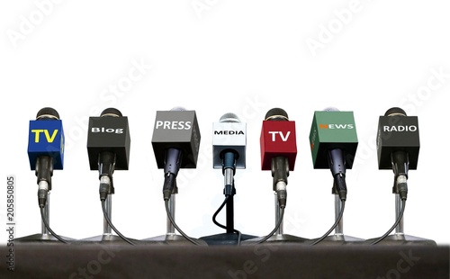 Press interview microphones on a table over white