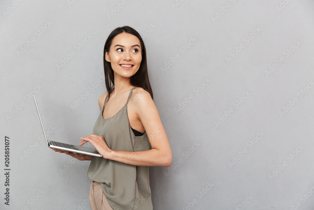 Portrait of a smiling asian woman using laptop computer Portrait of a smiling asian woman using laptop computer