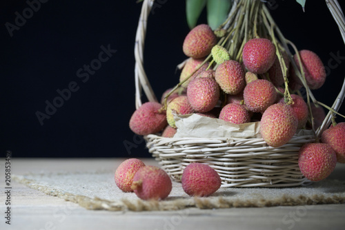 litchi, lichee, lychee, or lichi, Litchi in basket on black background