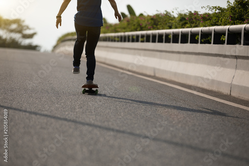 Fototapeta Naklejka Na Ścianę i Meble -  Skateboarder skateboarding on city street