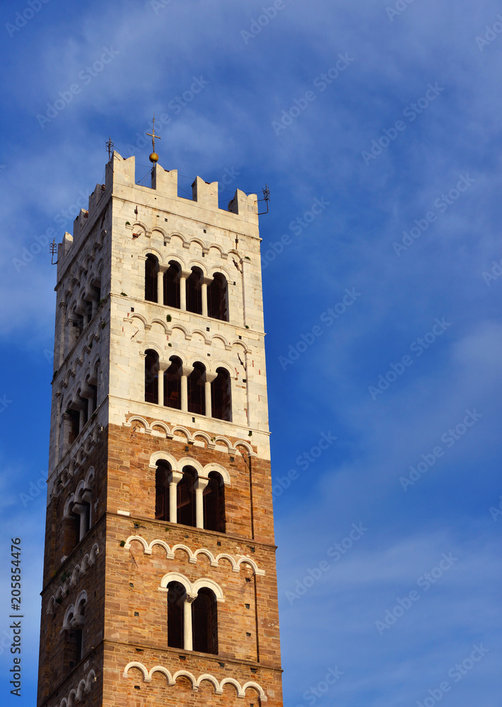 Lucca Cathedral medieval bell tower, erected in the 13th century (with clouds and copy space)
