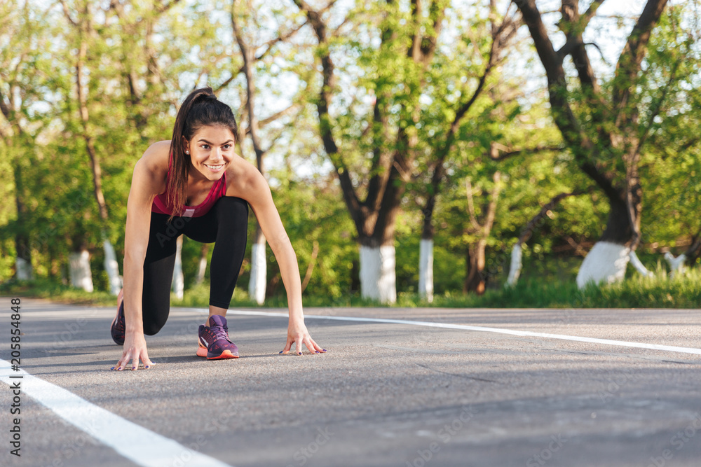 Concentrated young sportswoman ready to run Concentrated young sportswoman ready to run