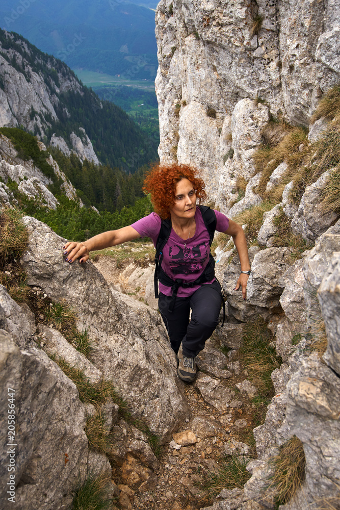 Woman climbing into the mountains