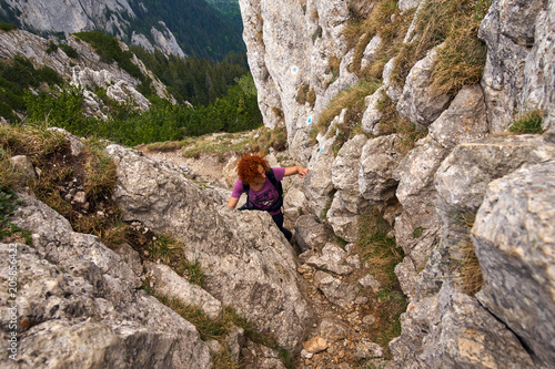 Woman climbing into the mountains