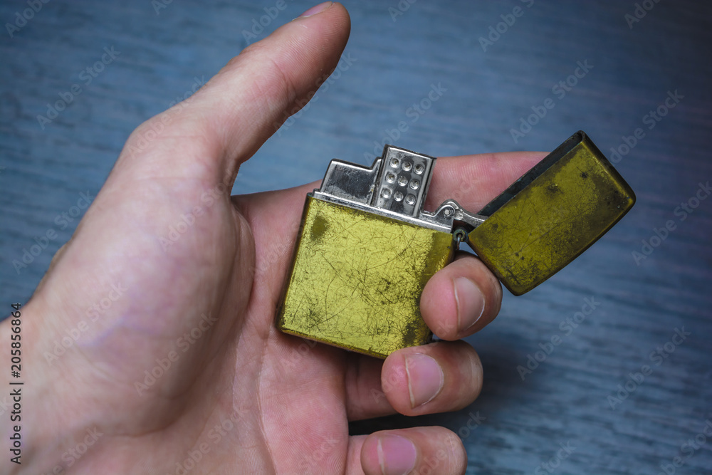 Fototapeta premium hand-held golden folding lighter